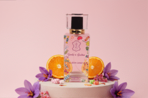 Bloom Candy perfume bottle for women with girly pink design inspired by Purple Oud, featuring woody oud, citrus, and spicy notes.